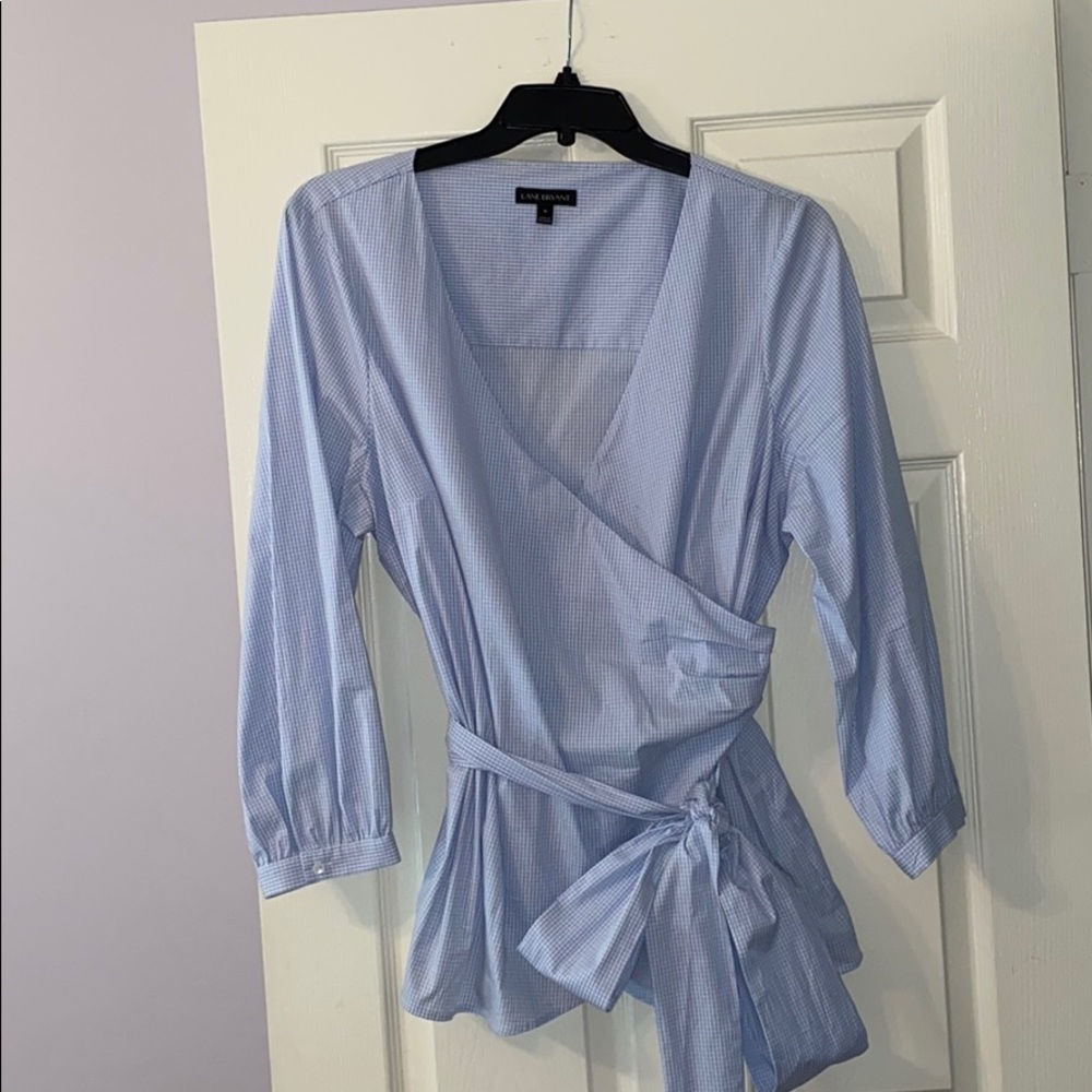 Wrap blouse that ties in bow at front.